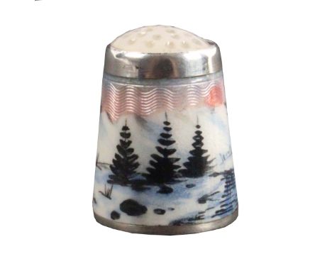 A Norwegian silver and enamel thimble, depicting a river, pine trees, in a snowy mountainous landscape below a moonstone top,