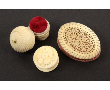 Two 19th Century ivory pin cushions and a waxer, comprising an oval pin cushion with finely fretted oval floral panel to each