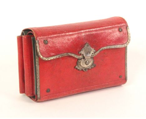 A good Georgian red leather and silver mounted purse form sewing companion, silver clasp, the green and red leather interior 