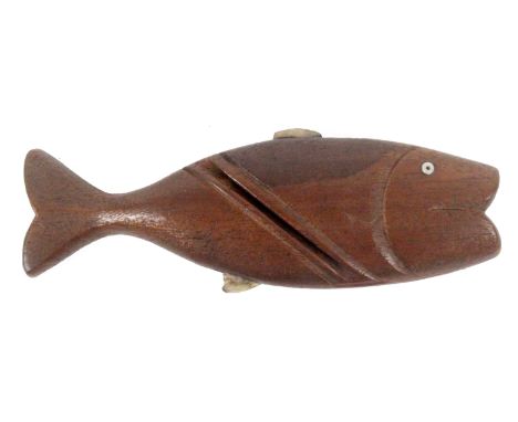 A mahogany knitting stick in the form of a fish, slightly curved, pearl fins, glass eye, 12.5cms. &nbsp; &nbsp; &nbsp; &nbsp;