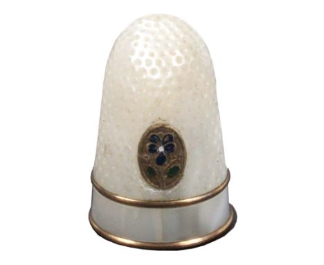 A good Palais Royal mother of pearl thimble, inset with an oval gilt and enamel pansy motif over two gilt bands and a plain f