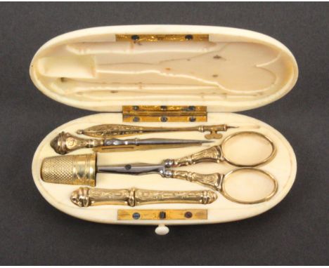 A late 19th Century ivory etui with engraved gold fittings, the case of oval form, the interior with engraved hinges and catc