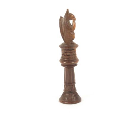 A Tyrolean carved wood standing needle case, the finial carved as a squirrel, an acorn raised to its mouth, 9cms.&nbsp; &nbsp