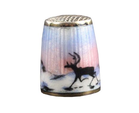 A Norwegian silver and enamel thimble, depicting two reindeer on the move against a winter landscape with midnight sun, below