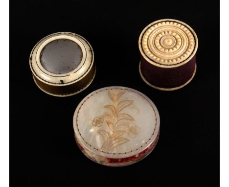 Three pin cushions, comprising a large mother of pearl disc form example one side engraved with a flowering stem, 5.2cms, ano