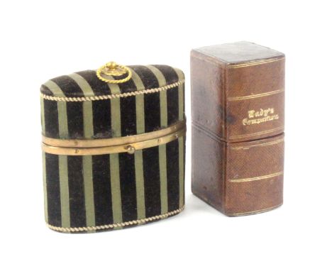 Two sewing companions, comprising a French example of oval form in green and black velvet stripes, gilt brass ring handle and