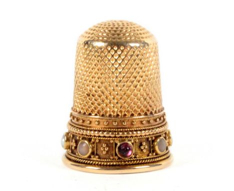 An attractive Victorian gold thimble, the frieze set with seven variously coloured pearls and a ruby coloured stone divided b