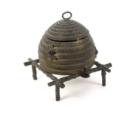 An unusual gilt metal sewing casket in the form of a bee skep, circa 1870, the surface dull, raised on a stand of rustic bran