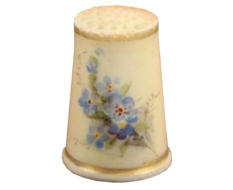 A Worcester blush ivory ground thimble, painted with forget-me-not between gilt lines, unmarked.&nbsp; &nbsp; &nbsp; &nbsp; &