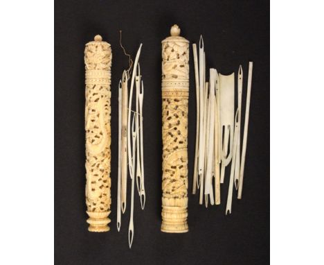 Two Chinese 19th Century ivory netting cases, complete with tools each of tapering cylinder form and carved with a coiled dra