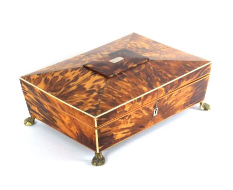 A good Regency tortoiseshell sewing box, of sarcophagal form edged in ivory, the lid with central raised tablet and engraved 