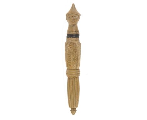 A rare Neopolitan carved lava needle case, the tapering cylinder body fluted and leaf carved, the finial in the form of a man