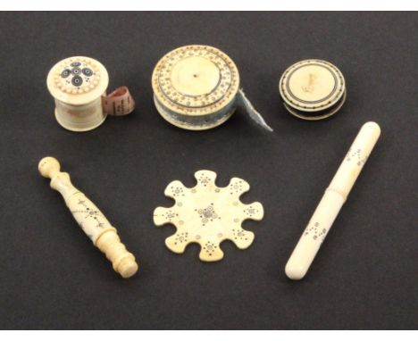 Six 19th Century Anglo-Indian ivory sewing tools, with burnt circle decoration comprising a cylinder tape measure with reduce