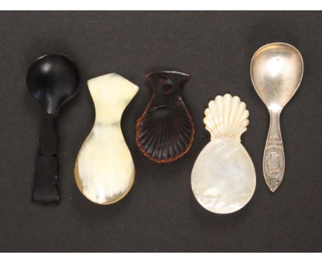 Five caddy spoons, comprising a mother of pearl example with carved handle, 7.5cms, a pressed tortoiseshell example, losses t