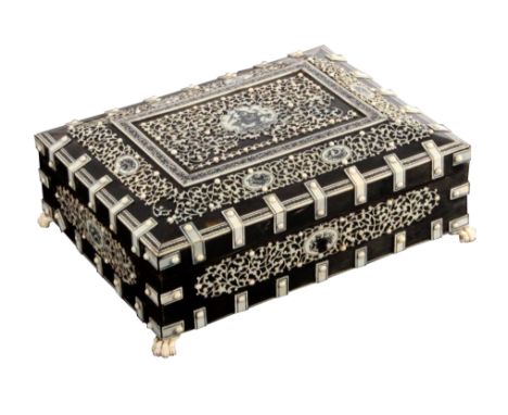 An Anglo-Indian horn and ivory mounted sewing box, circa 1830, of rectangular form with canted lid, the whole overlaid with p