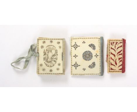 Three 19th Century needle books, comprising an ivory example, the covers pierced with an oval panel depicting a dog amid pier