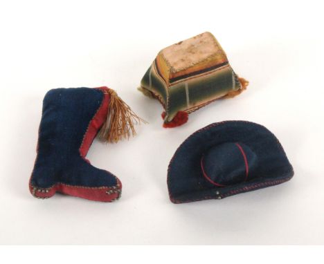 Three attractive material pin cushions, a red and blue silk hat, 5.5cms, a velvet and silk boot, 6cms, and a silk rectangular