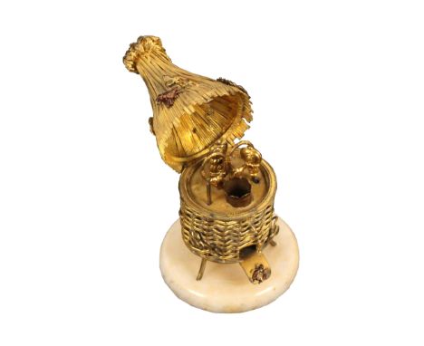 A Palais Royal style sewing companion in the form of a gilt metal bee skep, in simulated wicker with leaves and part enamelle
