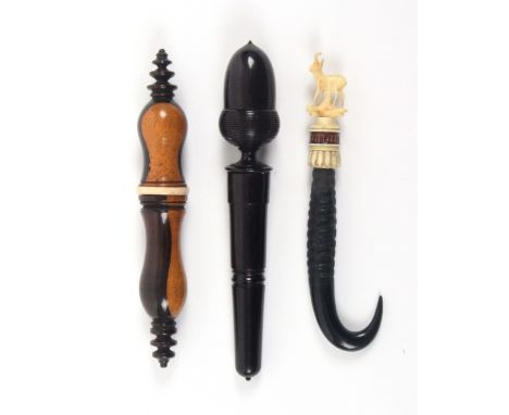 Three needle cases, comprising an early 19th Century baluster turned lignum vitae example with bone collar to screw joint, 11