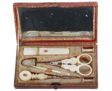 A small Palais Royal sewing companion, circa 1820, the rectangular case in grained red morocco with gilt tooling, the lid int