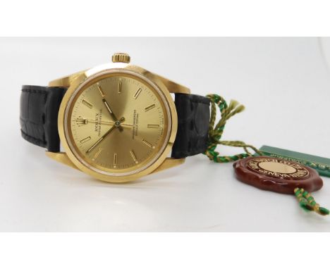 AN 18CT GOLD GENTS ROLEX OYSTER PERPETUAL with gold coloured dial, baton numerals and hands. back the case sticker number 142