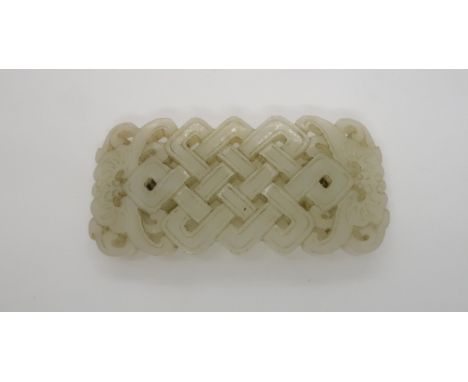 A CHINESE JADE BUCKLE the pierced lattice pattern flanked by bats, 4cm high and 9cm wide Condition Report:minute chips to edg