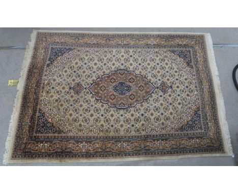A CREAM GROUND TABRIZ RUG  with a light terracotta medallion, matching borders and dark blue spandrels 298cm long x 209cm wid