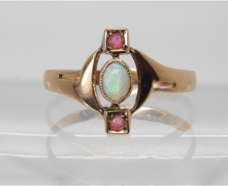 A GERMAN JUGENDSTIL OPAL AND RED GEM SET RING  stamped 333 for 8ct gold, finger size Q1/2, weight 1.5gms Condition Report:Ava