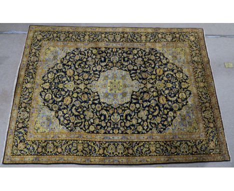 A DARK BLUE GROUND KASHAN RUG  with light blue central medallion ,matching spandrels and dark blue borders 333cm long x 242cm