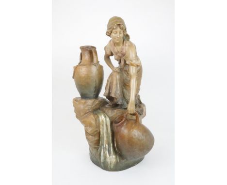 A GOLDSCHEIDER FIGURAL LAMP modelled as a girl crouching down with urns, 67cm high Condition Report:Available upon request