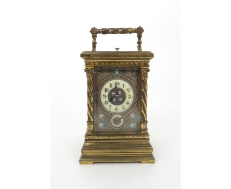 A FRENCH BRASS AND GLASS REPEATER CARRIAGE CLOCK with acanthus topped barley twist supports, the silvered dial with champlevé