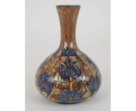 A DELLA ROBBIA POTTERY VASE of bottle shape, with relief decoration of blue flowers on a brown ground, incised mark to base a