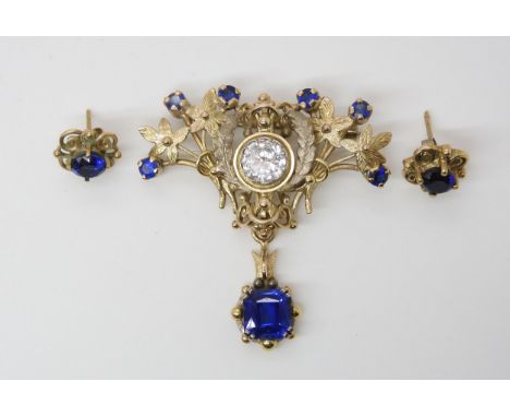 A BESPOKE ART NOUVEAU STYLE PENDANT/BROOCH AND EARRINGS  fashioned in yellow and white metal and set with blue and clear past