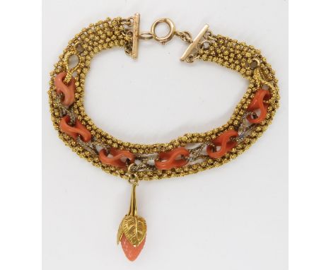 A THREE STRAND CARVED CORAL BRACELET hung with a carved coral strawberry with coral links very similar to the previous lot. L