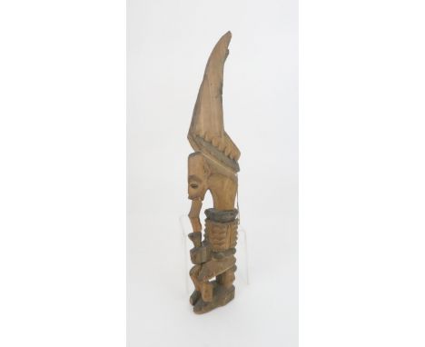 AN AFRICAN IKENGA SPIRITUAL FIGURE the horned creature seated on a stool, c.1900, 41cm highProvenance: The figure was brought