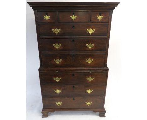 A GEORGE III ELM CHEST ON CHEST  the ogee cornice above three short and three long drawers, divided by a brush slide and abov