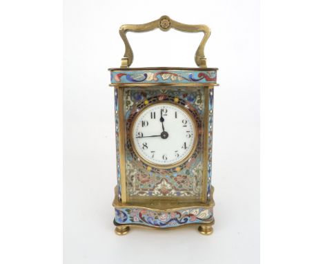 AN EARLY 20TH CENTURY FRENCH BRASS AND CHAMPLEVE ENAMEL CARRIAGE CLOCK the white dial with arabic numerals, with enamel surro