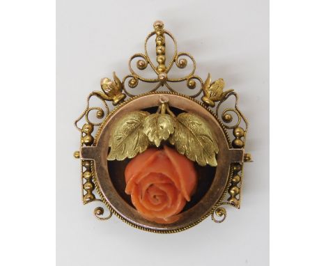 AN ART NOUVEAU PENDANT BROOCH set with a carved coral rose, dimensions 3.6cm x 2.8cm, weight 7.4gms Condition Report:Availabl
