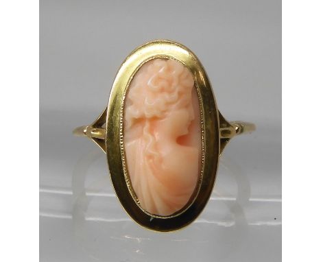 A CORAL CAMEO RING mounted in an 18ct gold millgrain setting, to a fleur de lis shouldered shank. finger size P1/2, weight 3.