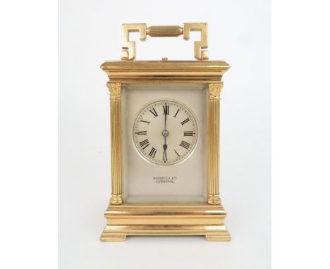 A FRENCH GILT METAL REPEATING CARRIAGE CLOCK with silvered face and dial with roman numerals, platform escapement, signed E. 