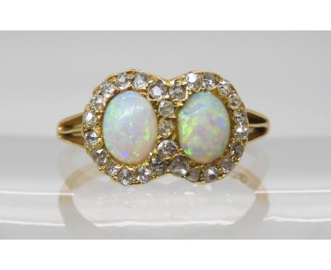 AN 18CT TWIN OPAL AND DIAMOND RING  the two opals measure approx 6mm x 4.7mm, surrounded with old cut diamonds, dimensions of