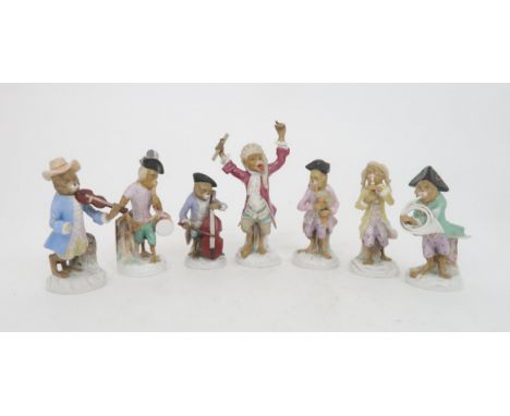 FIVE CONTINENTAL MONKEY BAND FIGURES in the style of Meissen including a bagpipe player, a French horn player, a conductor, a