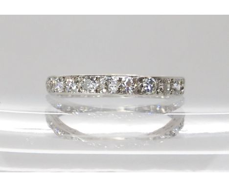 A FULL DIAMOND ETERNITY RING grain set in white metal. set with estimated approx 0.88cts of brilliant cut diamonds. Size R, w