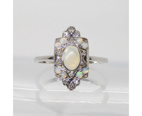 A 10K WHITE GOLD, OPAL AND DIAMOND DECO STYLE RING  set with nine white opals and brilliant cut diamonds, in an elegant confi