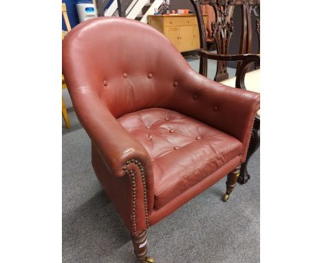 Button back red leather armchair on casters, seat ht 43 cms, full ht 87cmsSome wear to leather, 1 button missing on the seat 