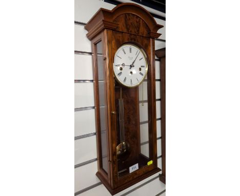 Wood cased wallclock by Comitti, London; with glazed front & sides, pendulum & key presentHt 67 cms, clock face 14.5cms diame