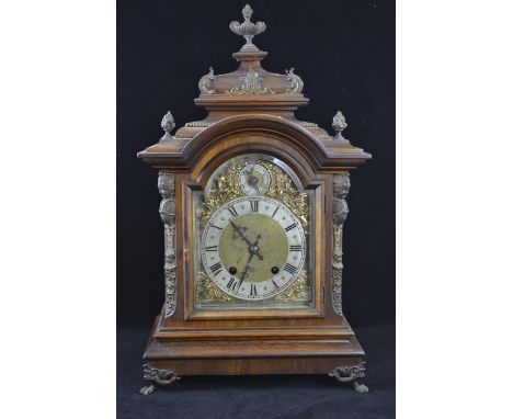 Ornate mantle clock with 2 dials ,gilt decoration around the face, with key and pendulum. Ht 48.5cmsworm damage to left hand 
