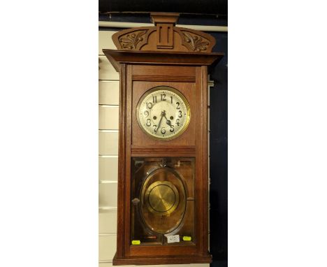 Arts and crafts oak cased wall clock with glazed front, key & pendulum present, clack face diameter 18 cms, full ht 77 cms 