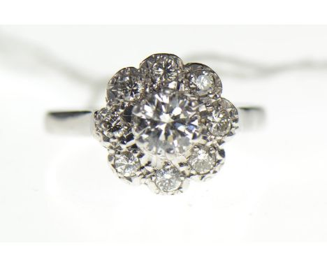 18ct white gold diamond cluster ring, set with nine stones, central stone weight calculated at 0.55 carat, size R, gross weig