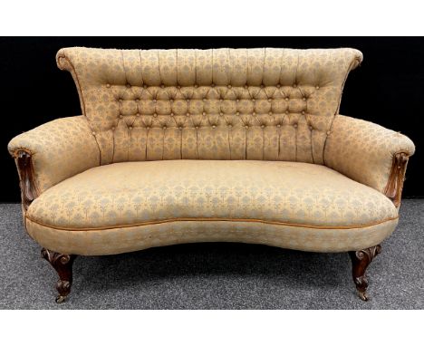 A Victorian walnut sofa, of small proportions, deep-buttoned stuffed-over upholstery, carved scroll arms and cabriole legs, c